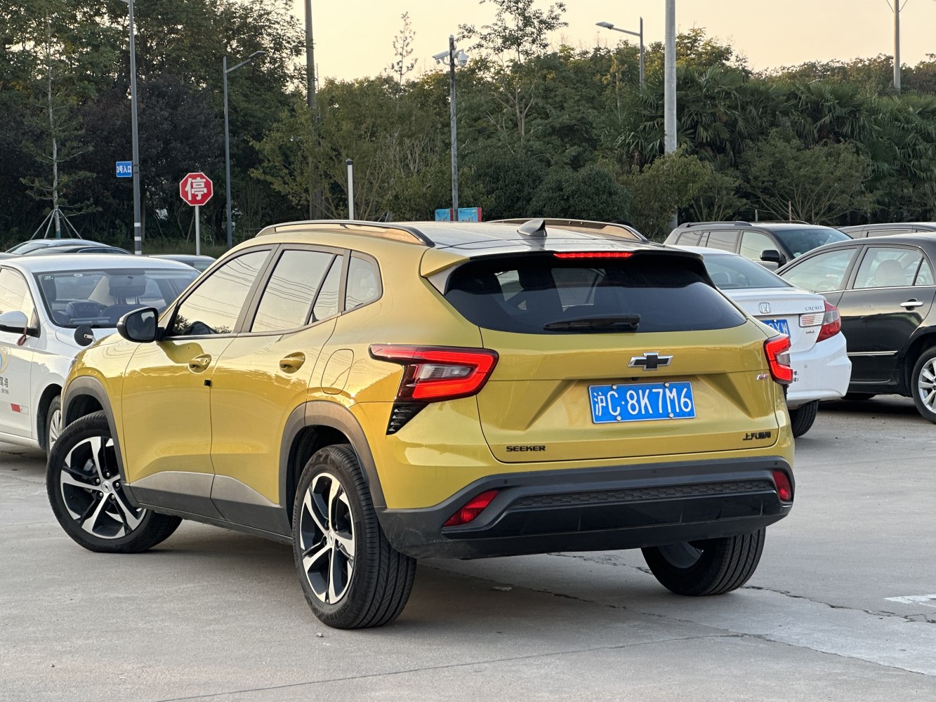 Rear view of yellow SUV with distinctive LED taillights and black trim