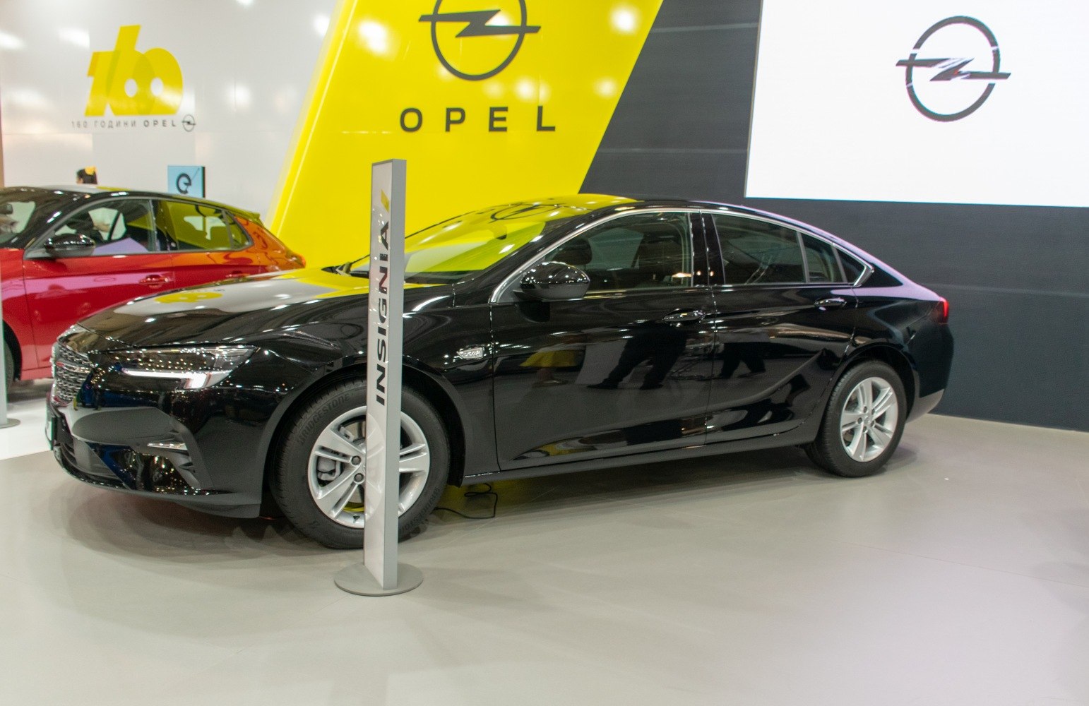 Black mid-size sedan with LED headlights and alloy wheels side profile