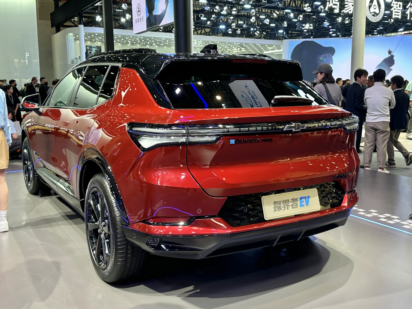 Sleek rear view with full-width LED tail lights and black roof accents.