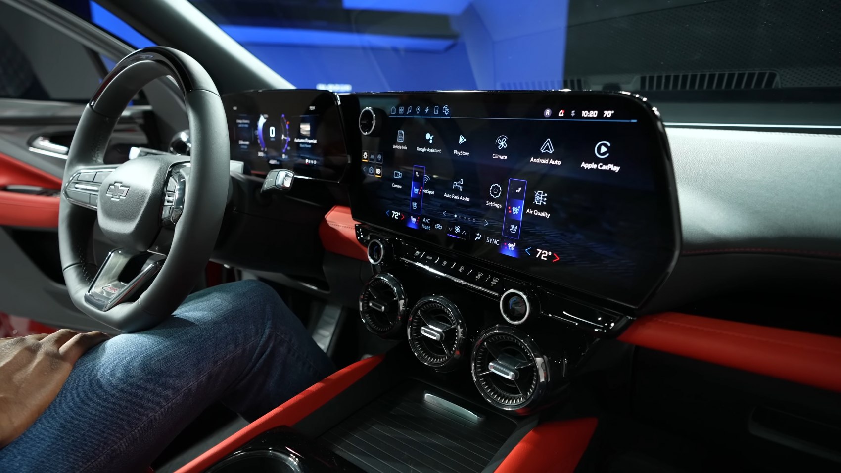 Dual digital screens, round climate control vents, leather interior accents