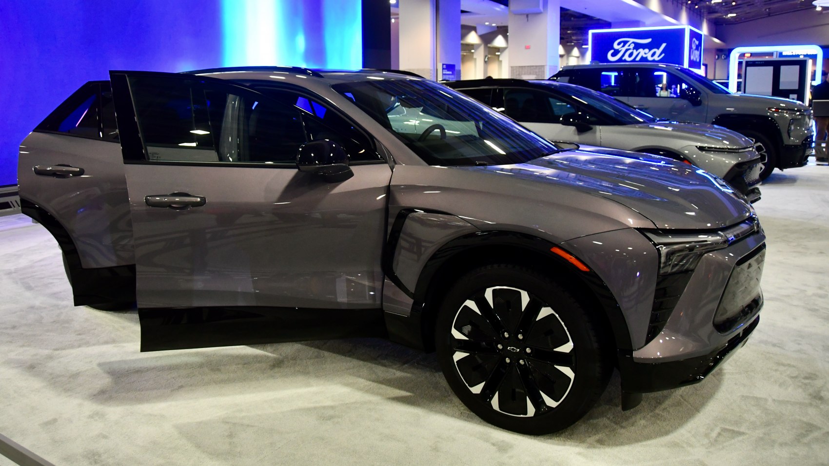 Front side of electric SUV with LED headlights and open front door