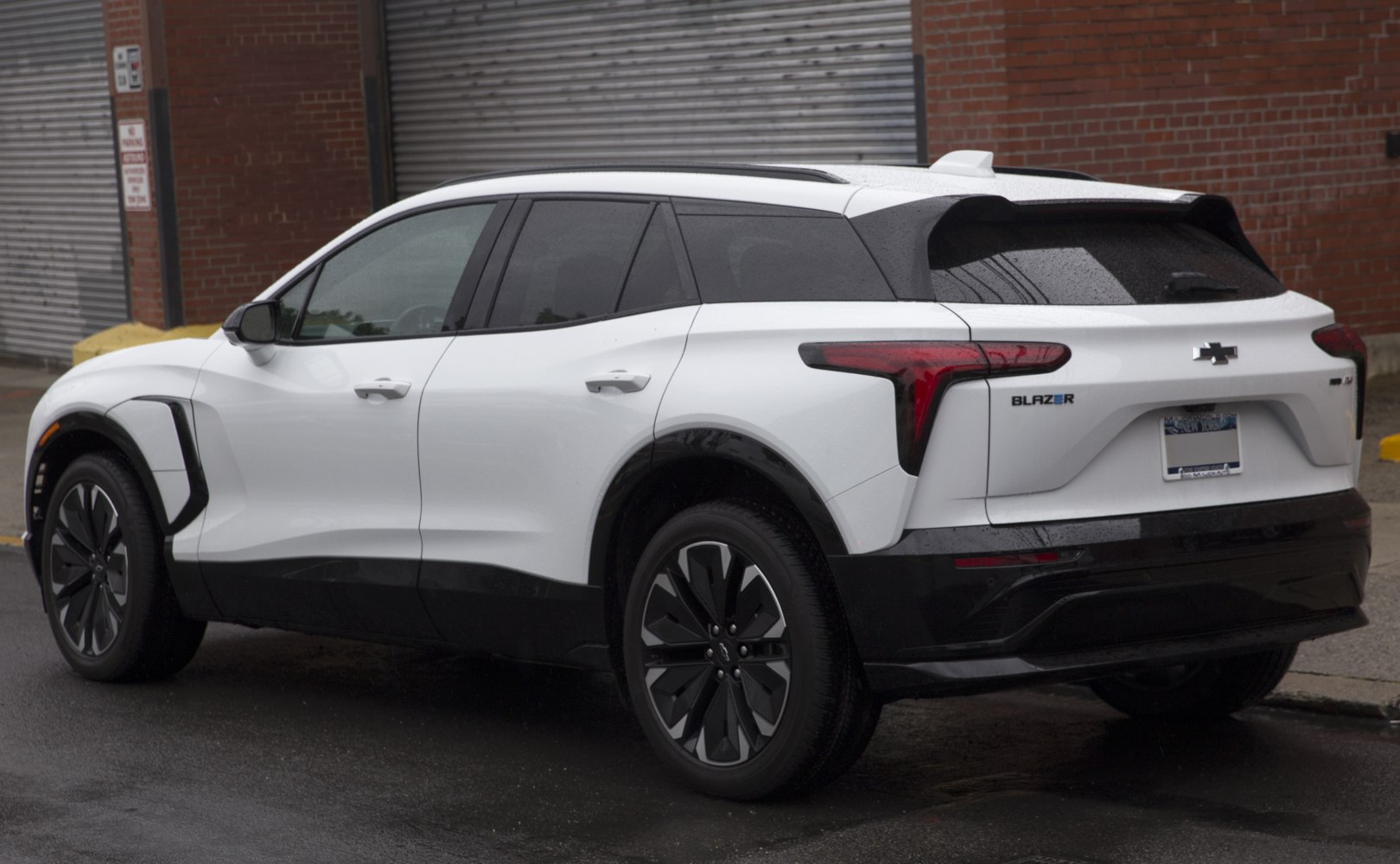 Rear side view of an electric SUV with modern tail lights and sleek side profile