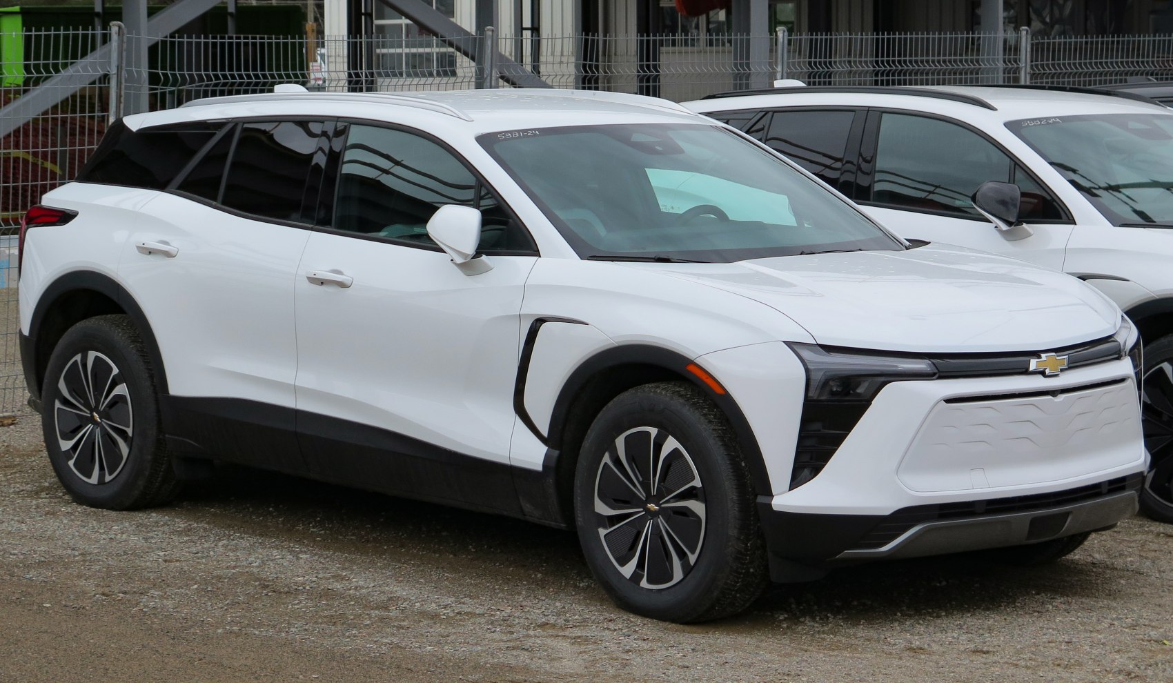 Front three-quarter view of white electric SUV with aerodynamic styling