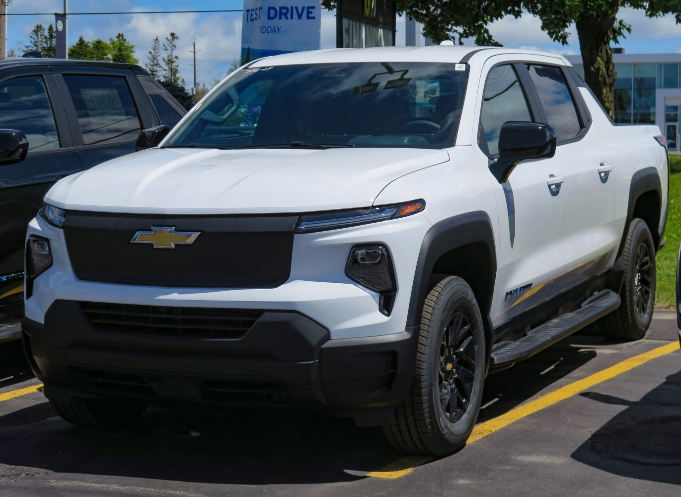 Front three-quarter view with black grille, LED lights and running boards