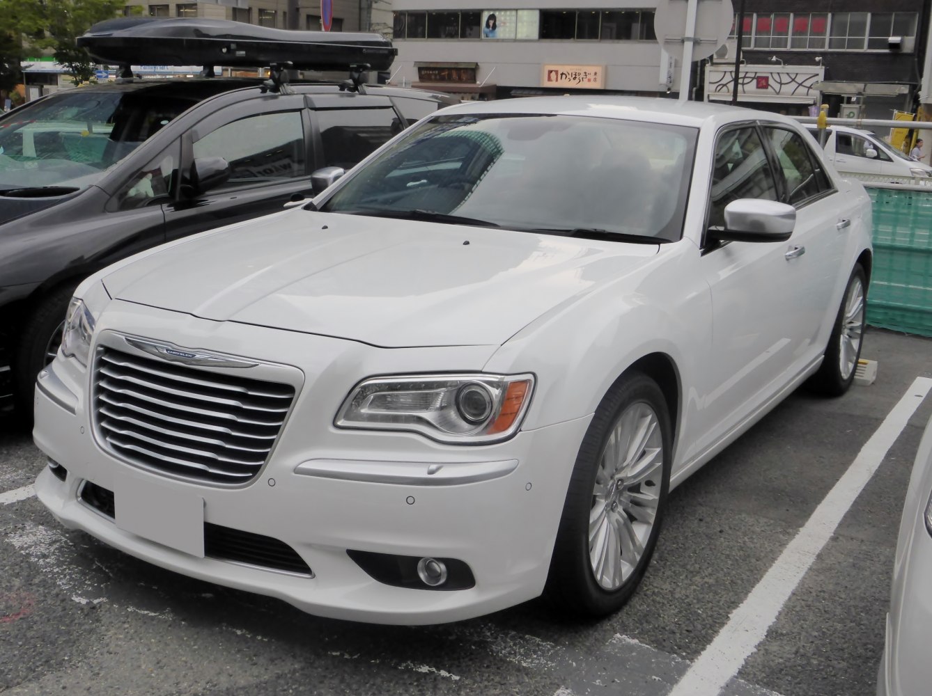 White luxury sedan with distinctive grille and modern headlights