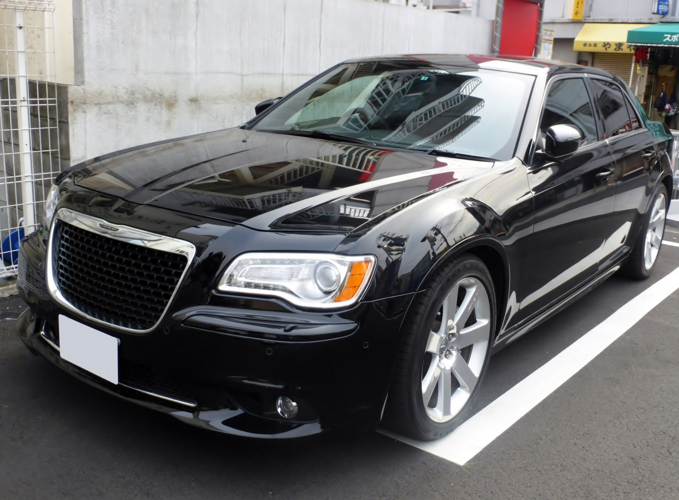 Black luxury sedan with chrome grille and LED headlights