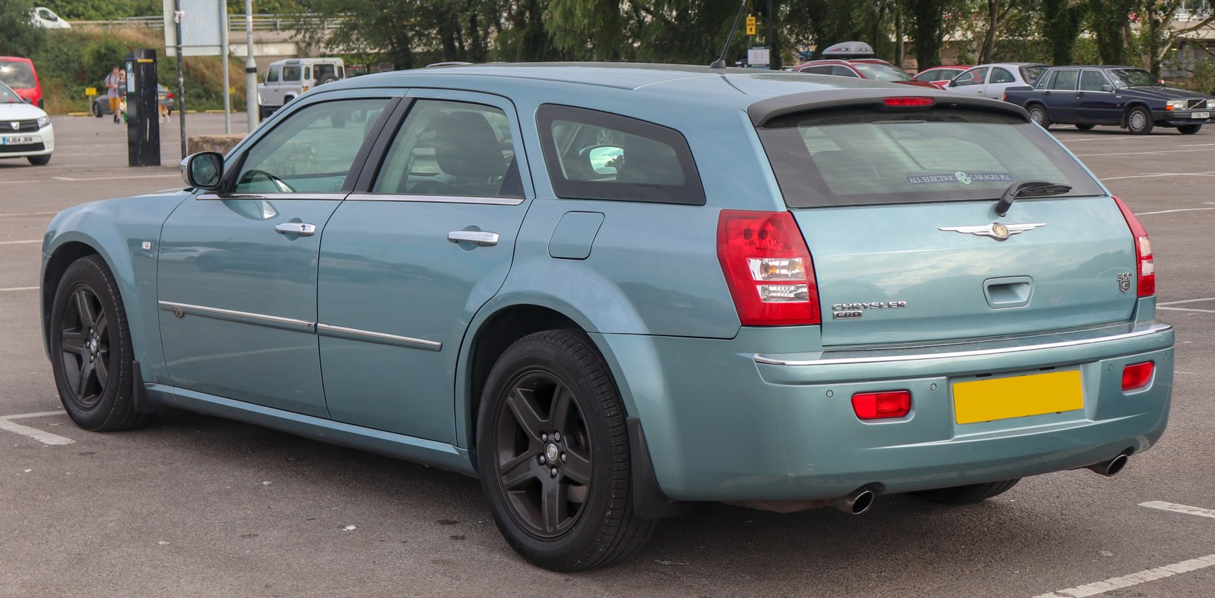 Rear side of station wagon with black alloy wheels and rear spoiler