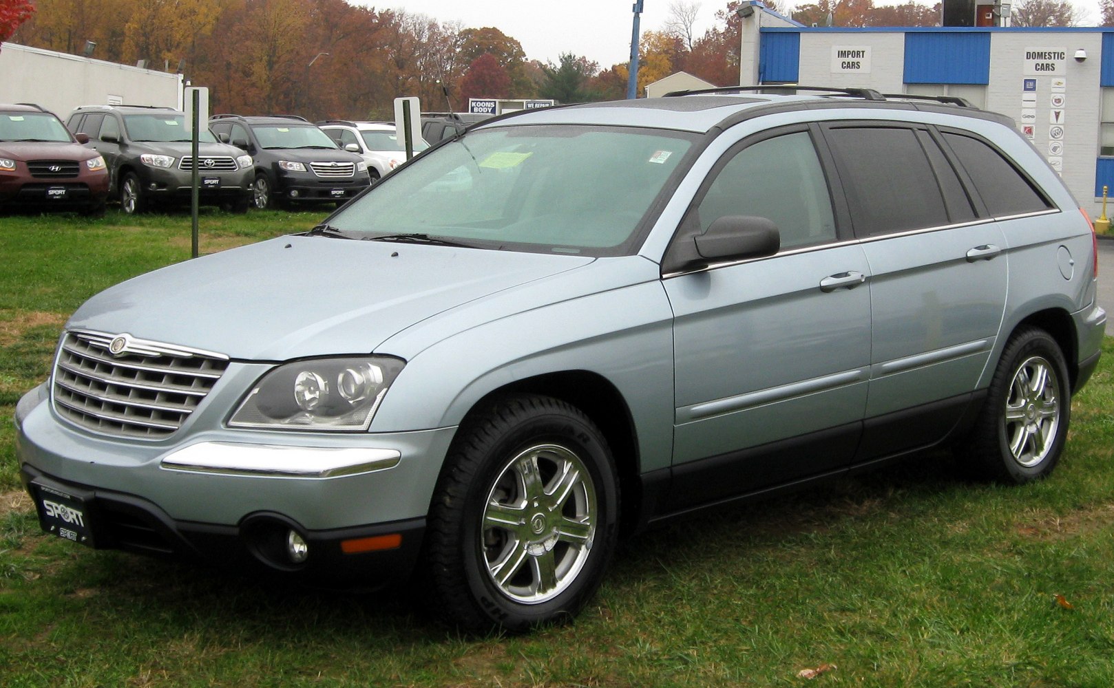 Front-side view of crossover with chrome wheels and tinted windows