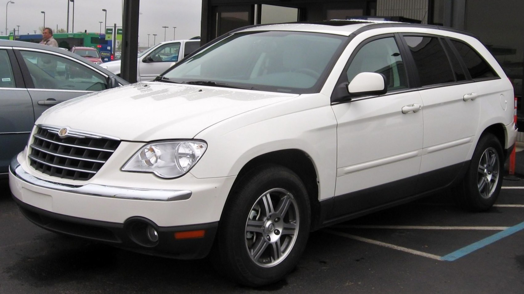 White crossover SUV front and side profile with grille and headlight details.