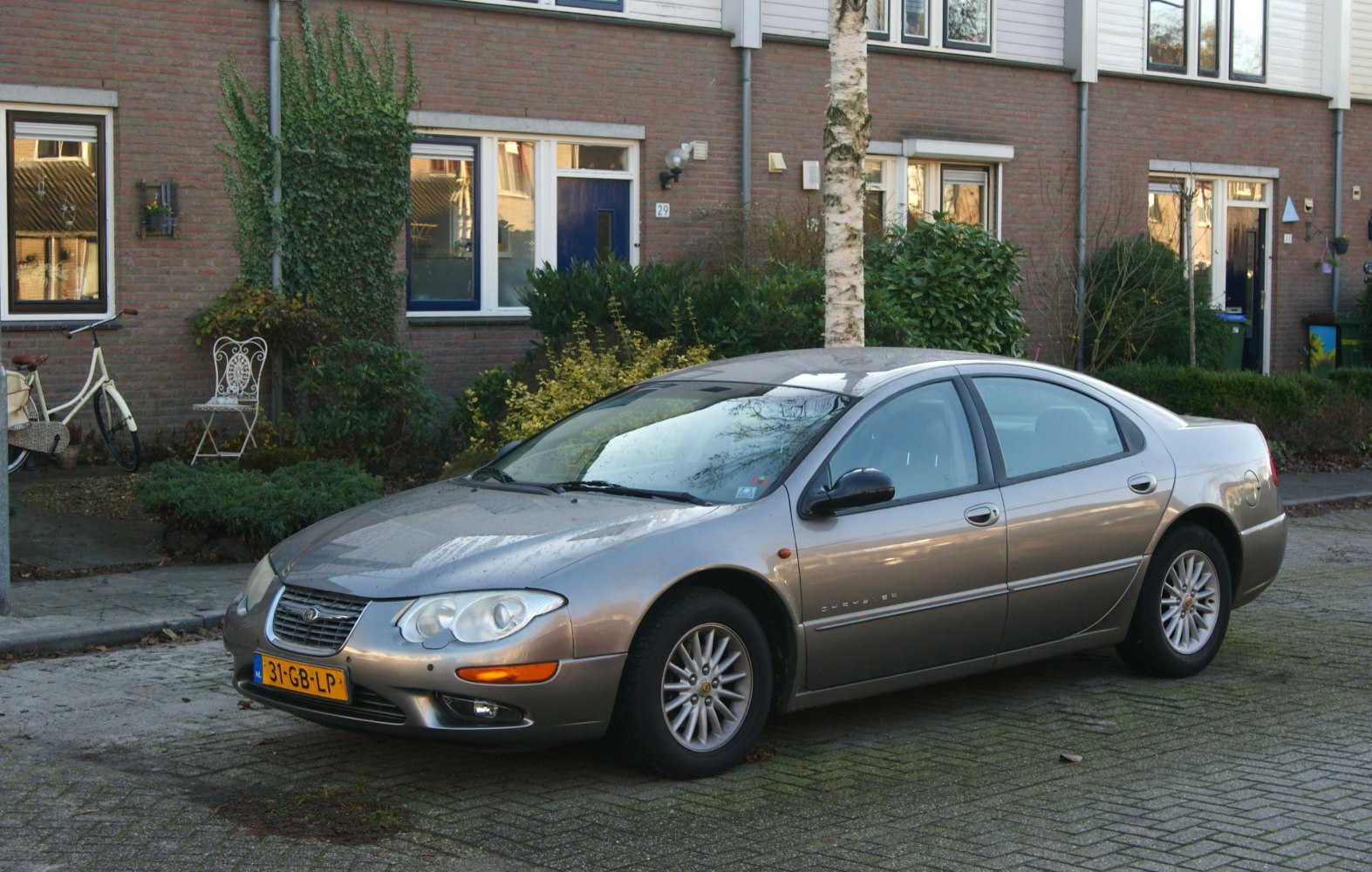 Sedan with distinctive headlights and multi-spoke alloy wheels.