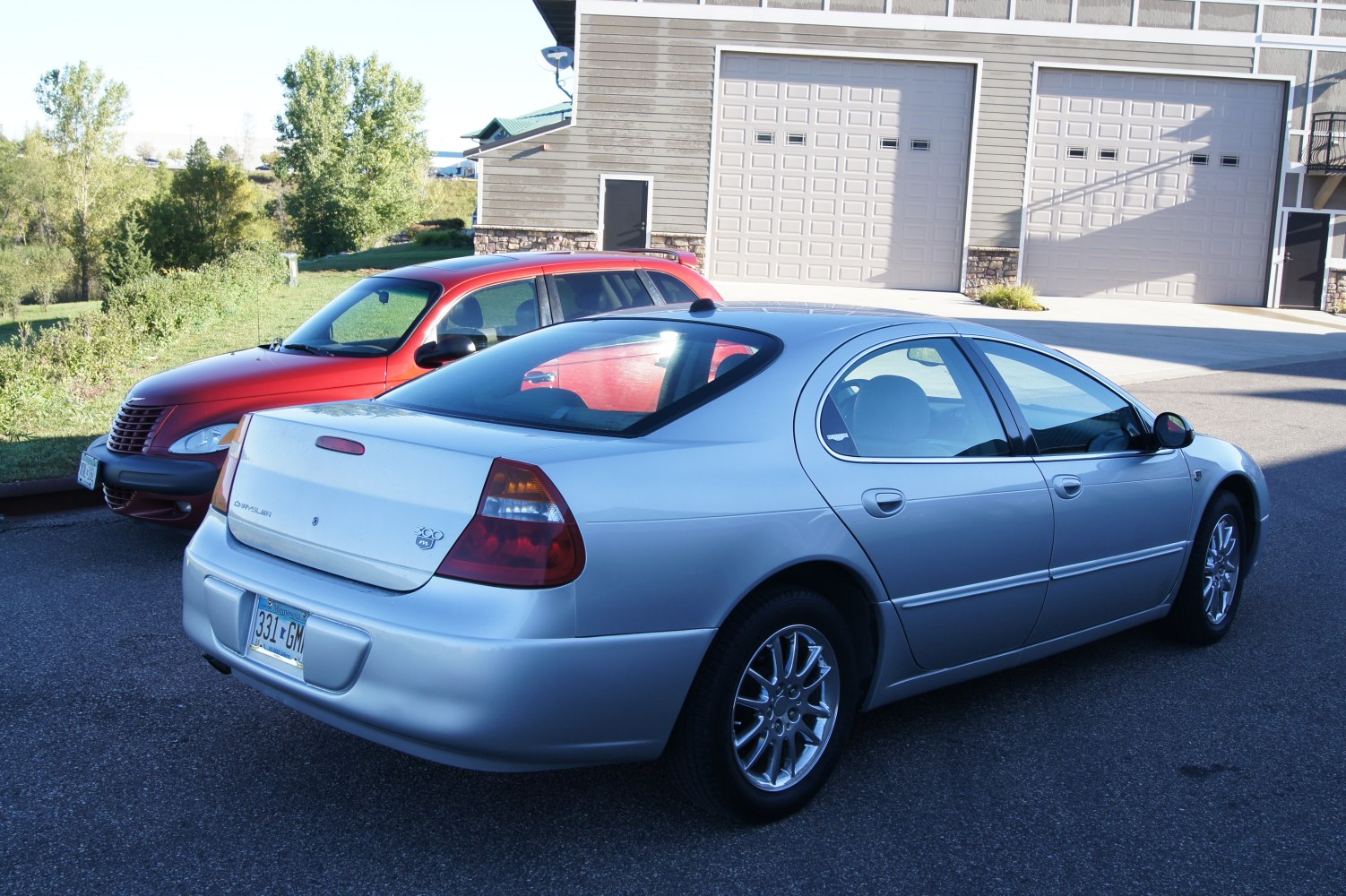 Silver sedan rear side view with distinctive alloy wheels and smooth body lines