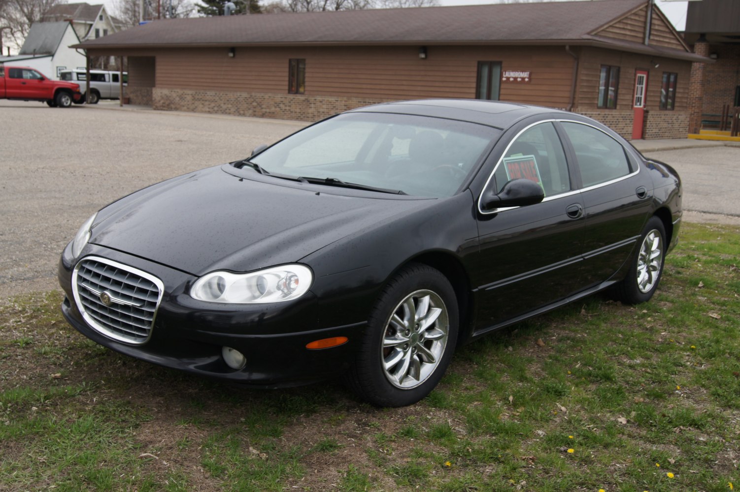 Front angled view with chrome grille and alloy wheels