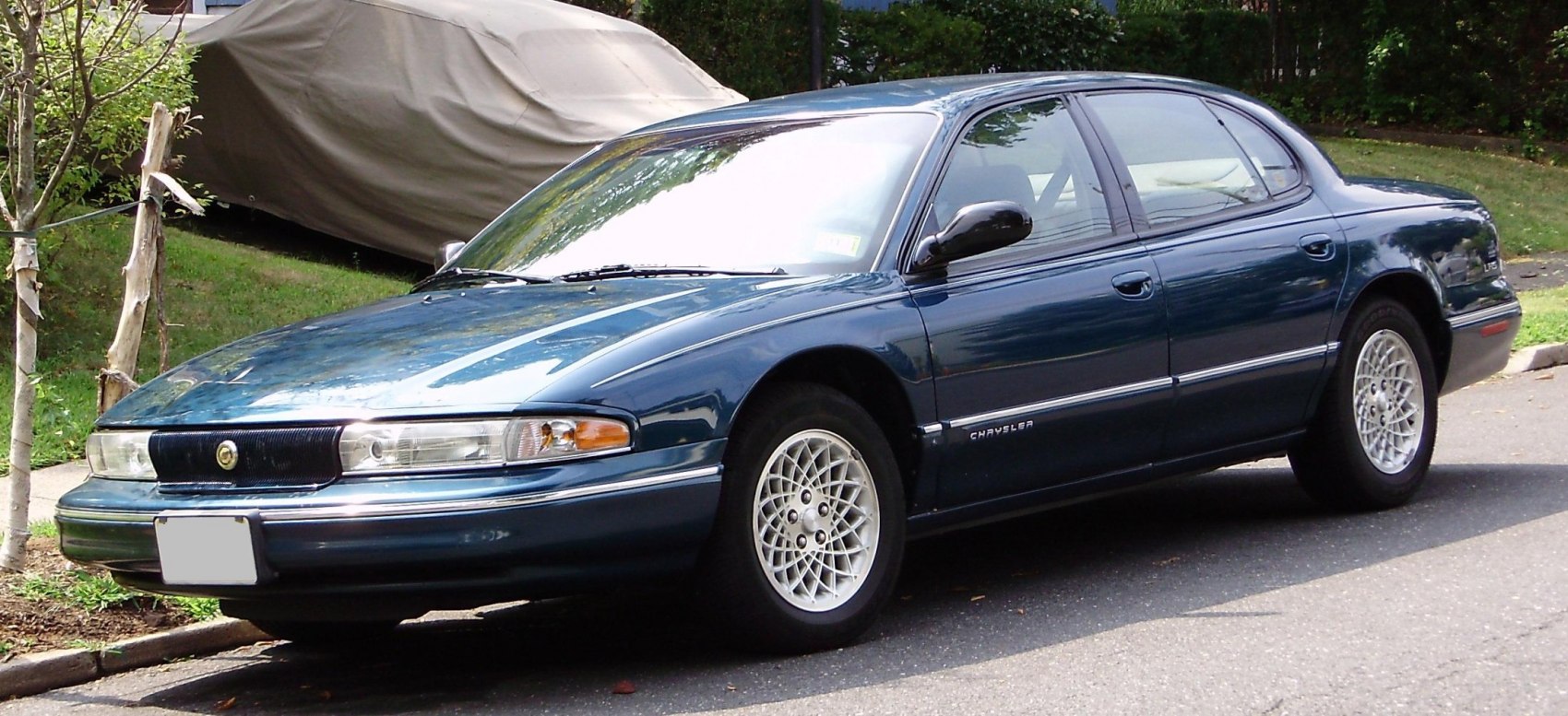Full-size sedan with mesh alloy wheels and polished blue exterior