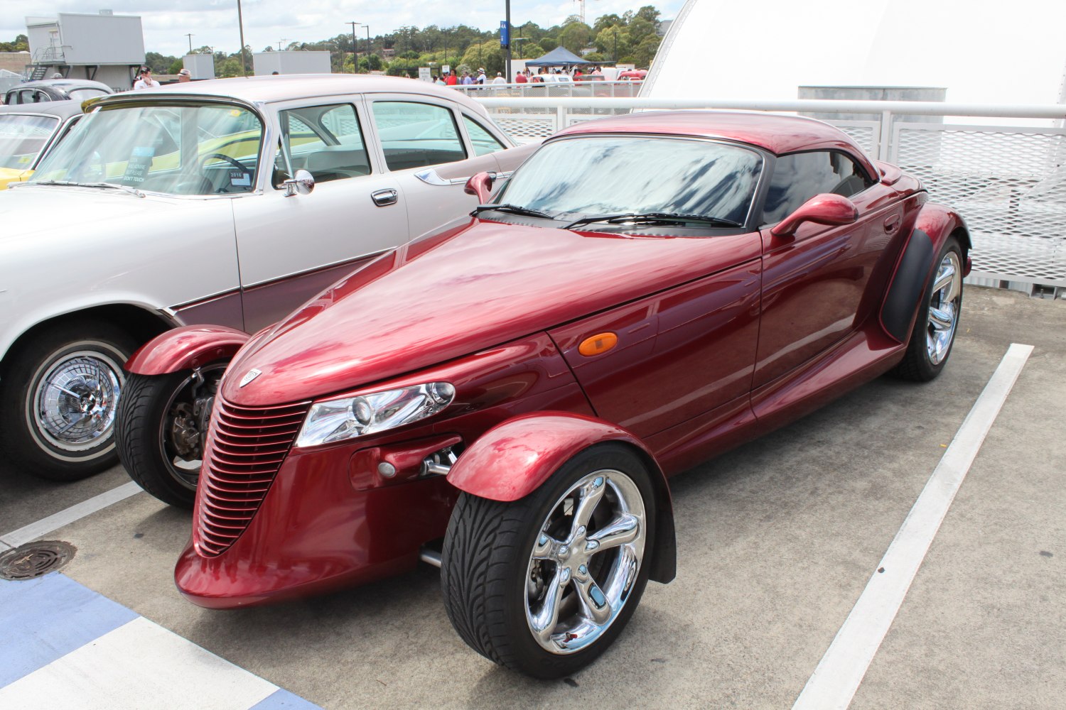 Retro-style roadster with exposed front wheels and sleek aerodynamic body.