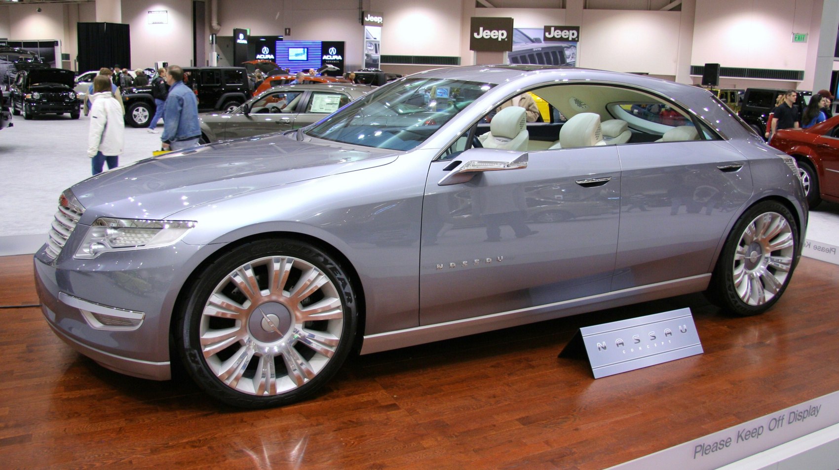 Luxury sedan with sleek design and large alloy wheels on display