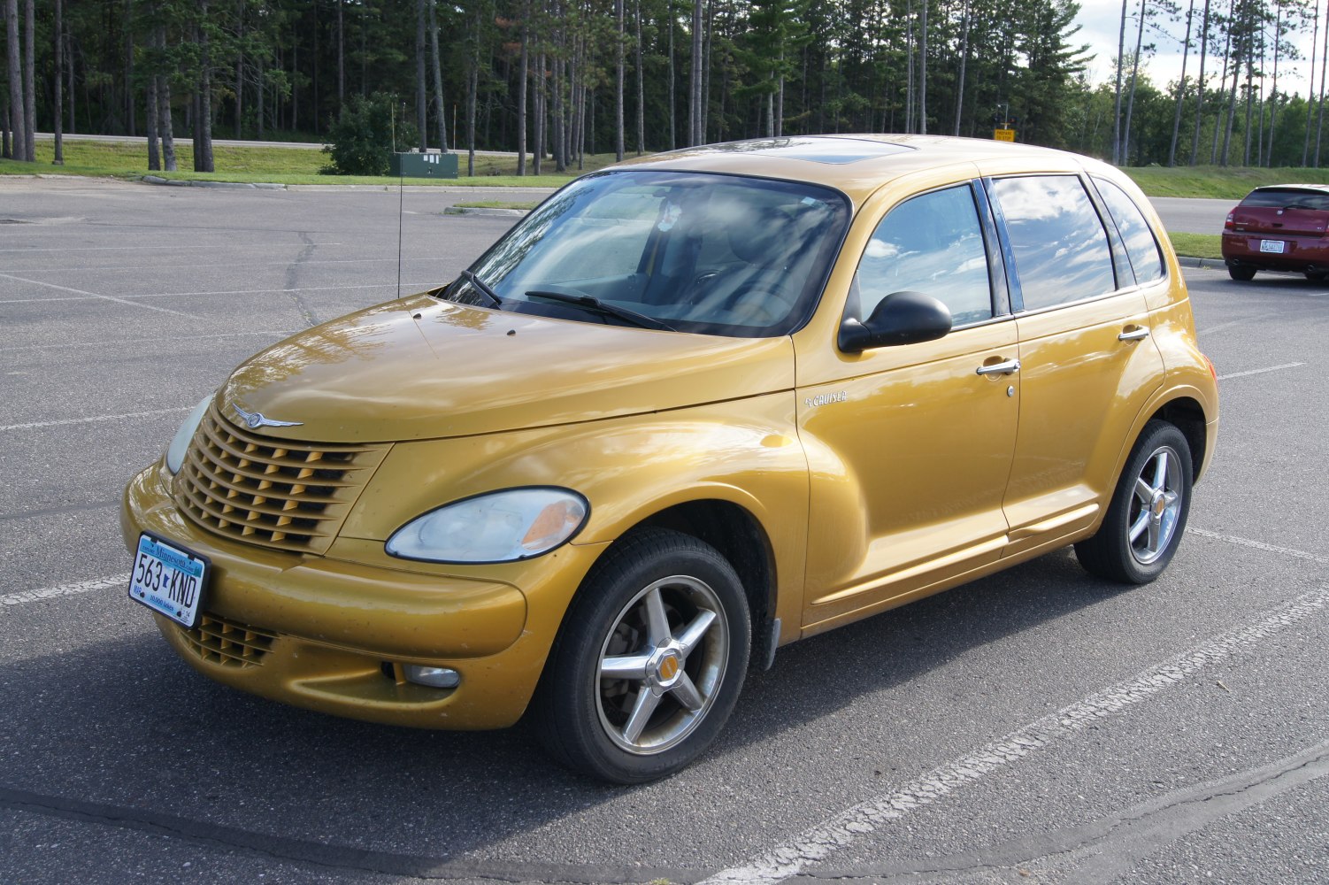 Compact retro-style car with chrome grille and rounded headlights
