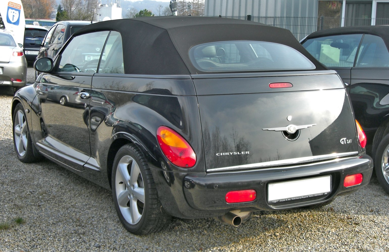 Rear view of a convertible with soft top and distinctive taillights