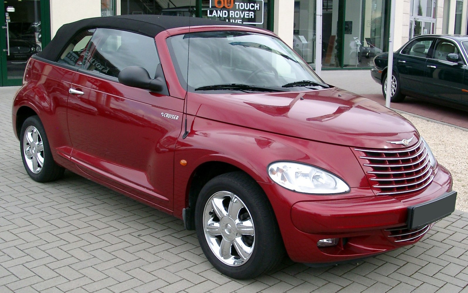 Convertible car with retro styling and chrome wheels