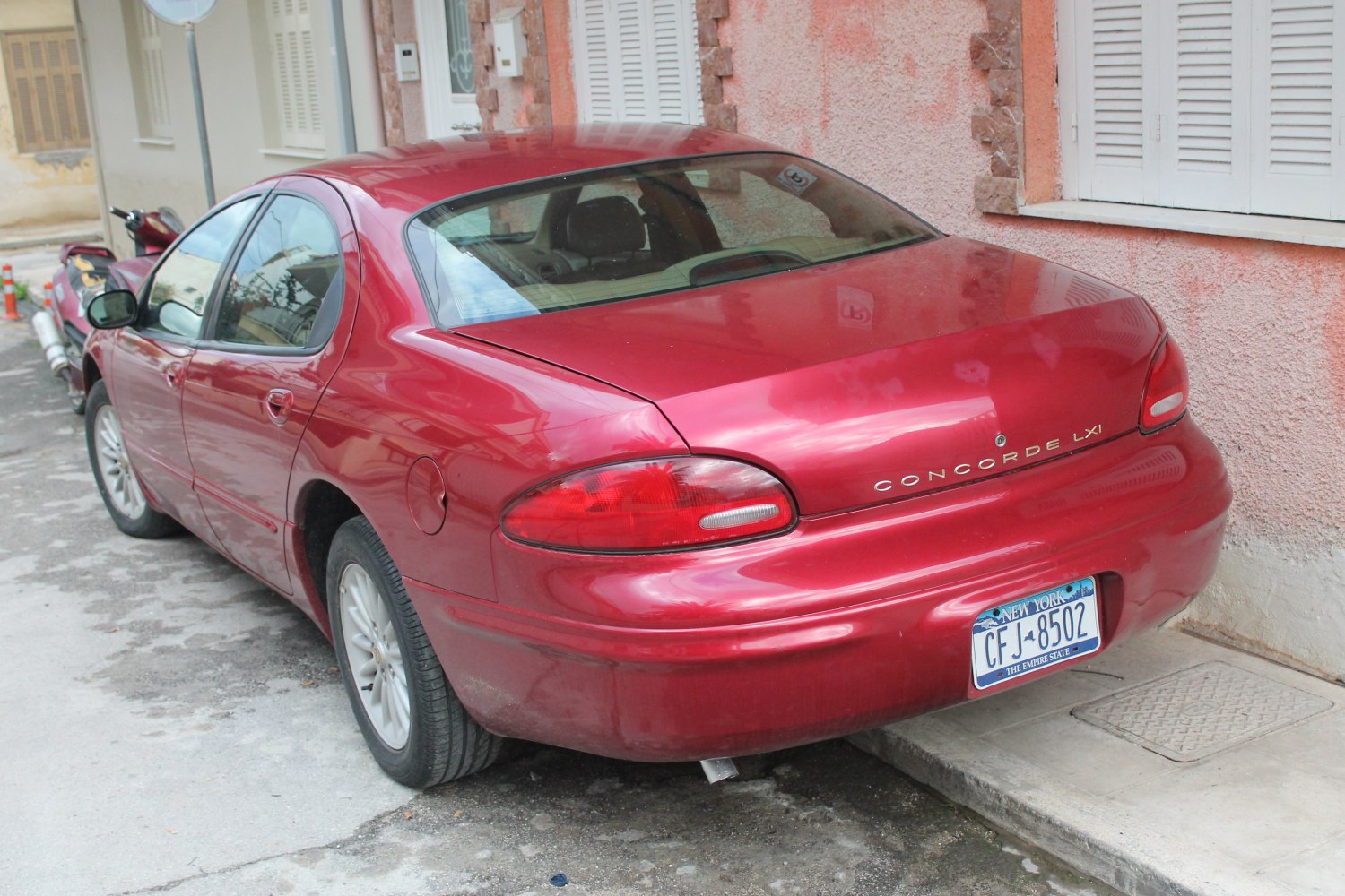 Rear sedan view with rounded tail lights and smooth trunk design