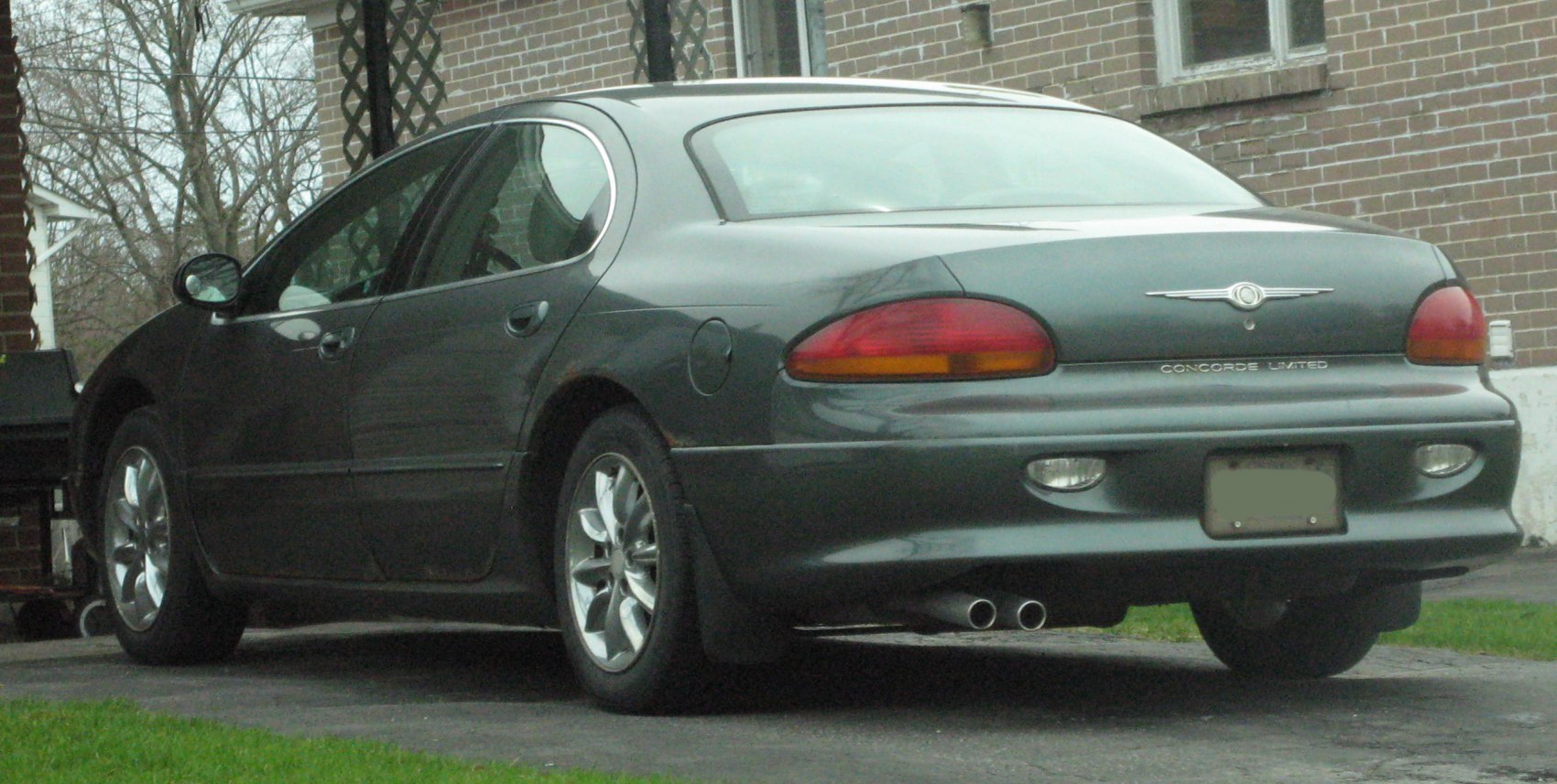 Rear view with dual exhaust pipes and oval tail lights