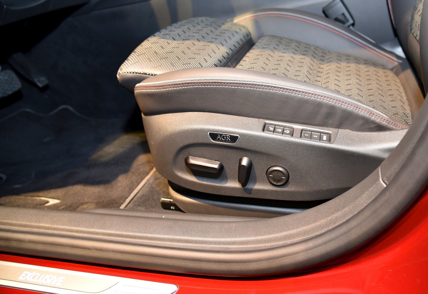 Front car seat with electronic adjustment controls and AGR certification