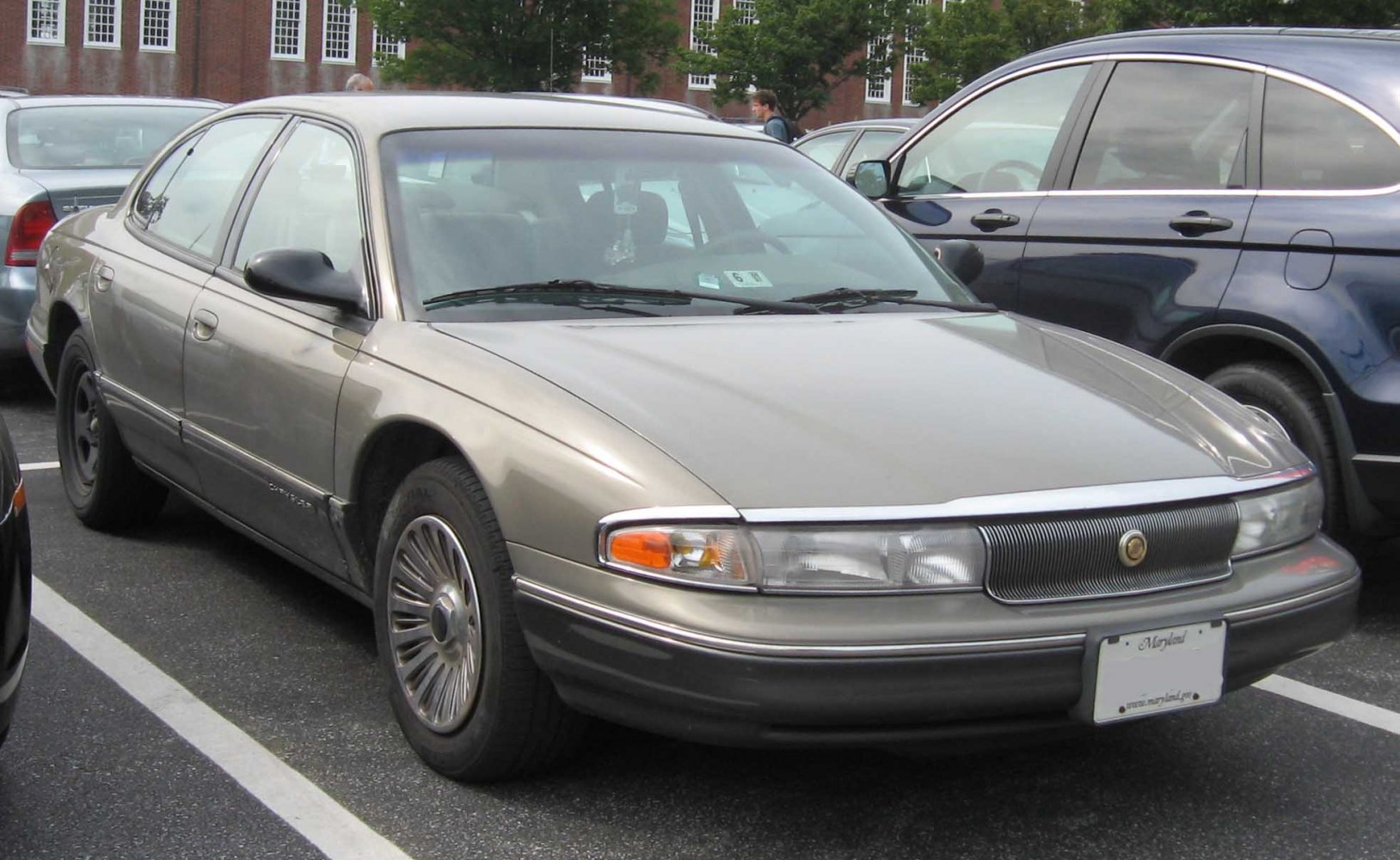Full-size sedan with long hood and distinct narrow headlights