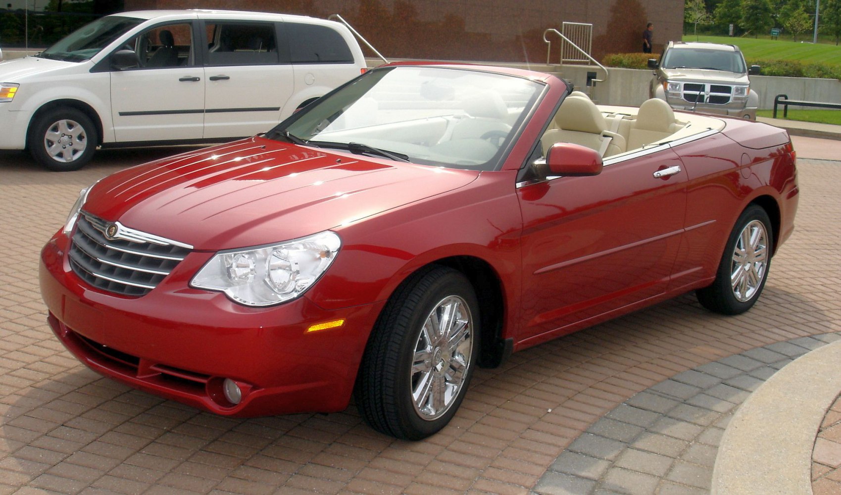 Red convertible with chrome wheels and beige interior