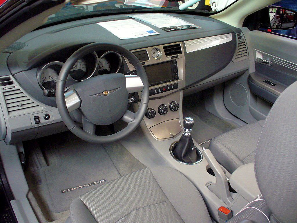 Manual transmission interior with dashboard and steering wheel.