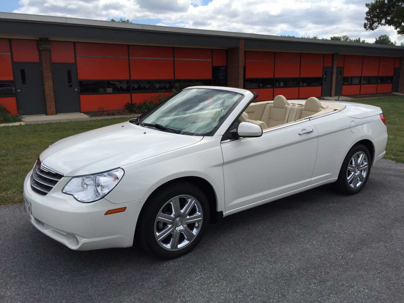 White convertible with beige leather interior and chrome wheels