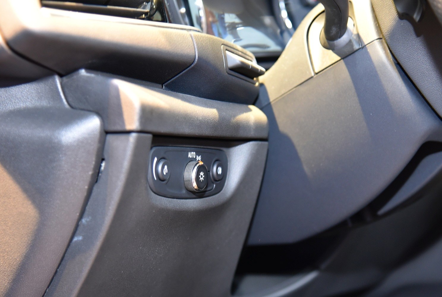 Headlight control panel with rotary knob and buttons