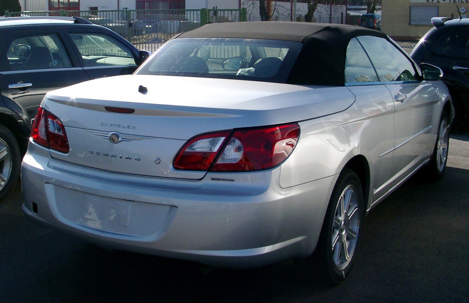 Rear view of a convertible with soft fabric roof and distinctive taillights