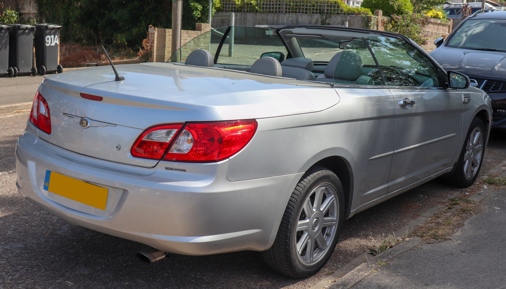 Silver convertible with rear antenna and detailed rear lights