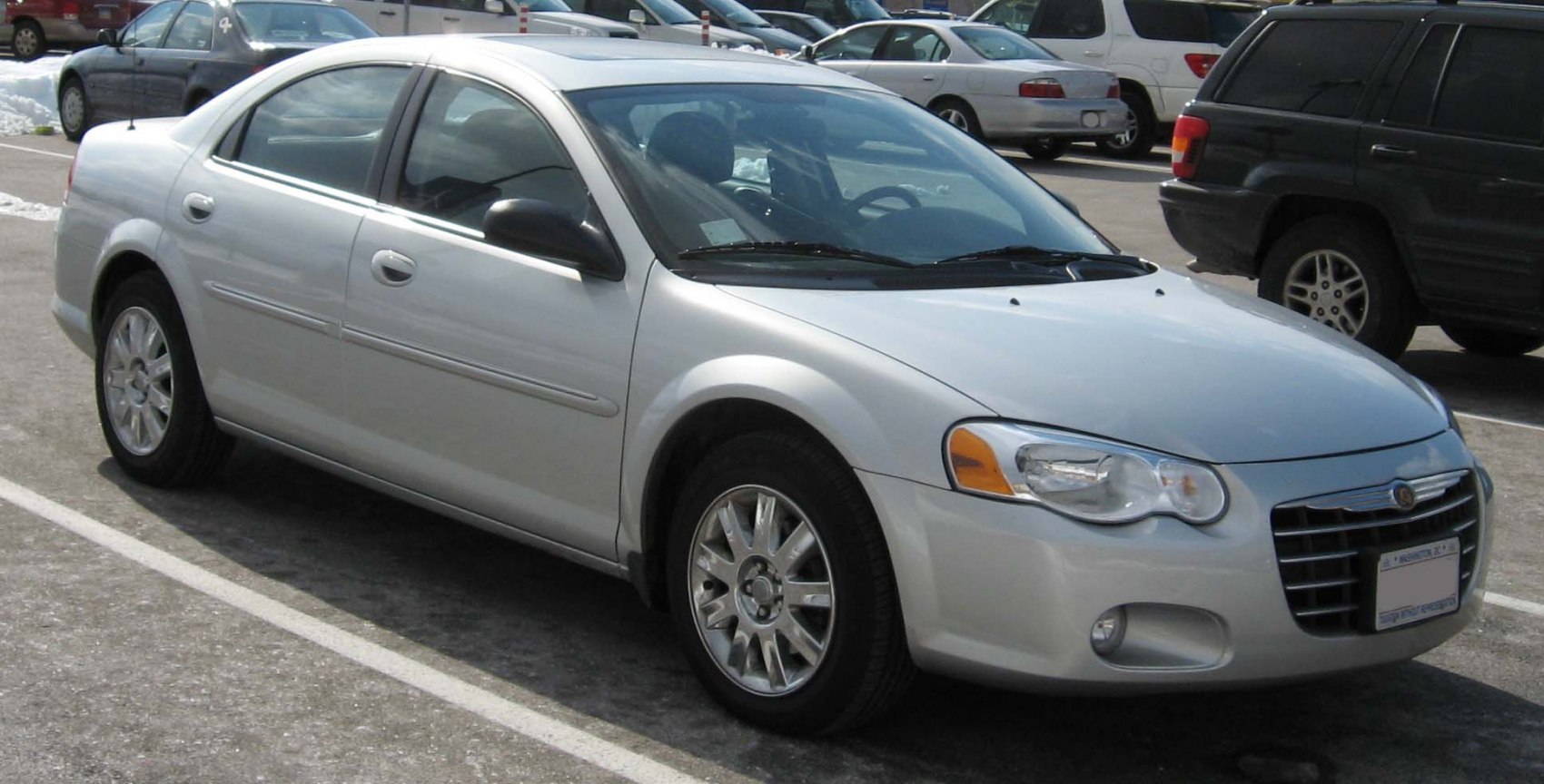 Silver sedan car front side view with alloy wheels and distinct grille.