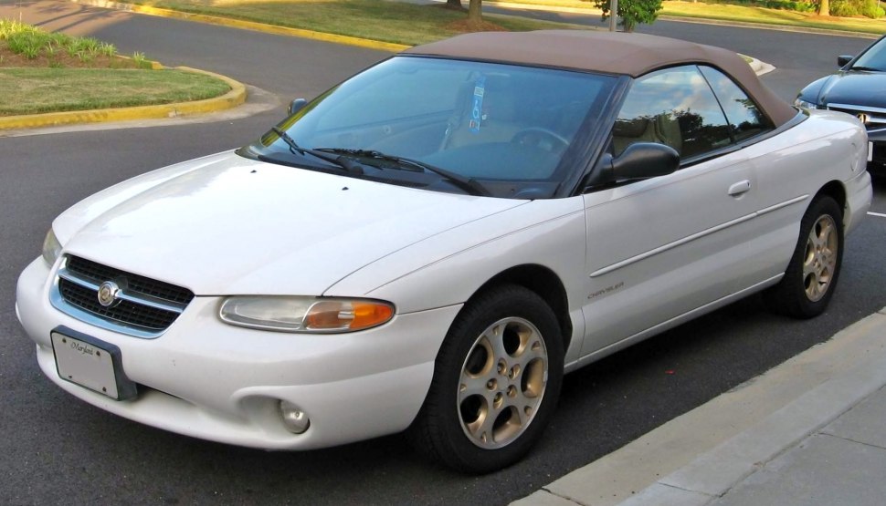 White convertible with soft brown top and rounded aerodynamic front.