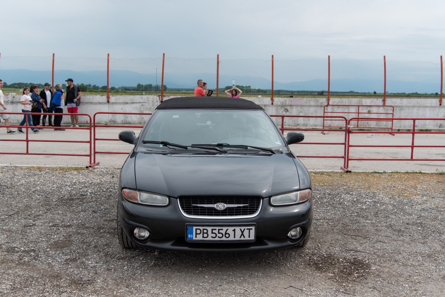 Front view of classic convertible with soft-top roof and distinct grille