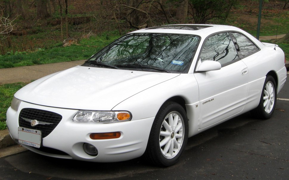 Front 3-quarter view of white coupe with rounded headlights and smooth body lines
