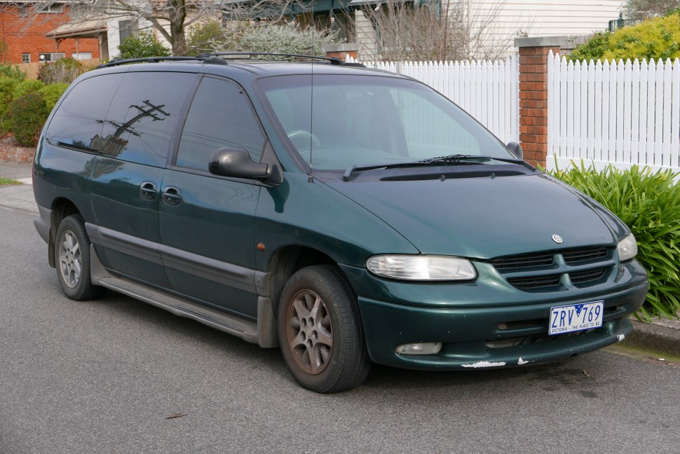 Front side view of a 1990s minivan with sliding doors and distinctive front grille