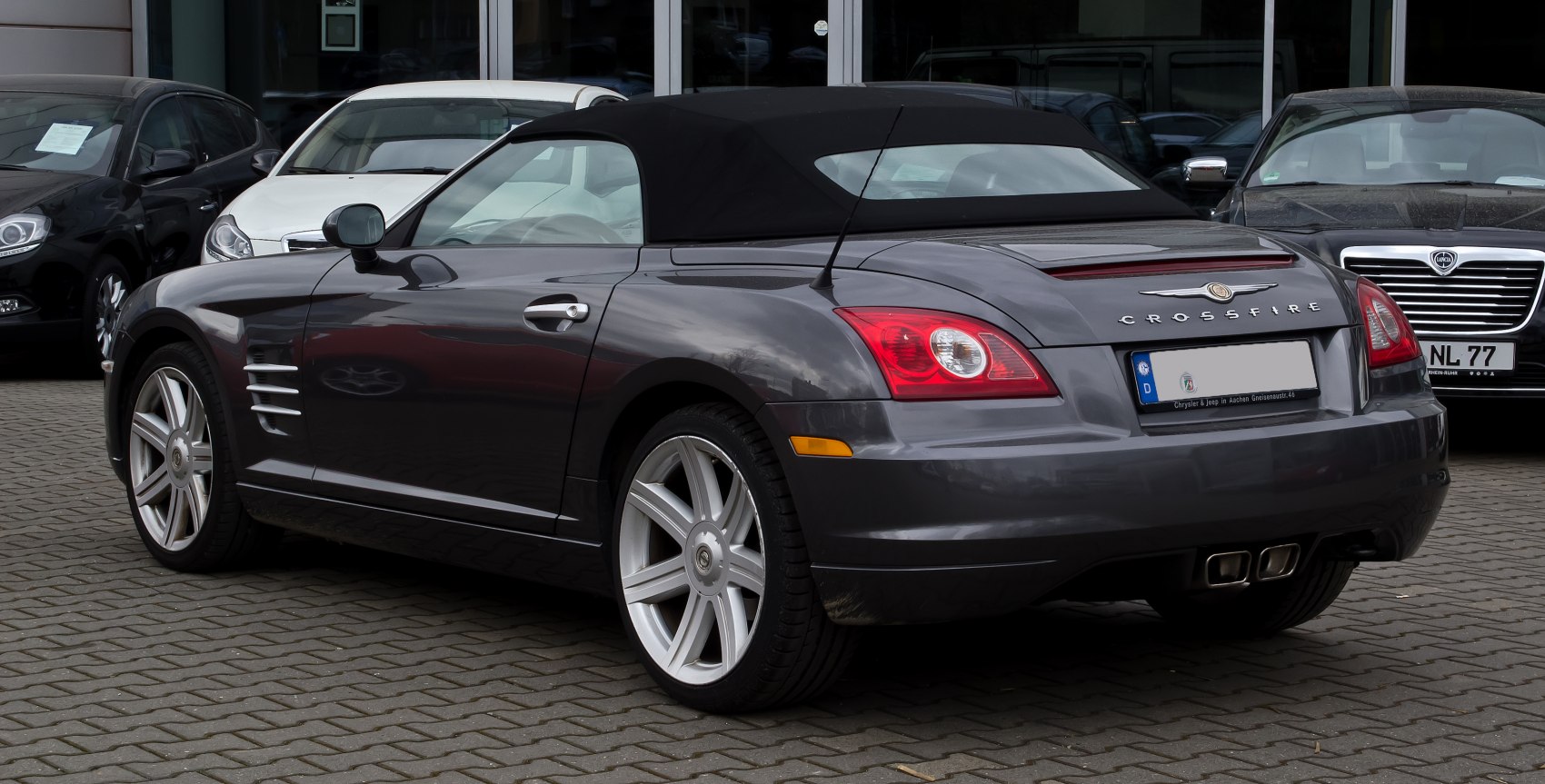 Rear view of a convertible with distinctive tail lights and dual exhaust