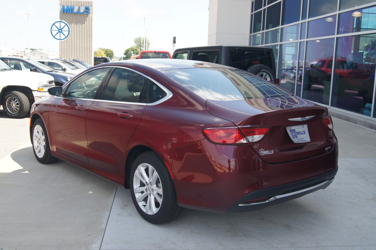 Sleek sedan rear and side view with elegant curves in deep red.