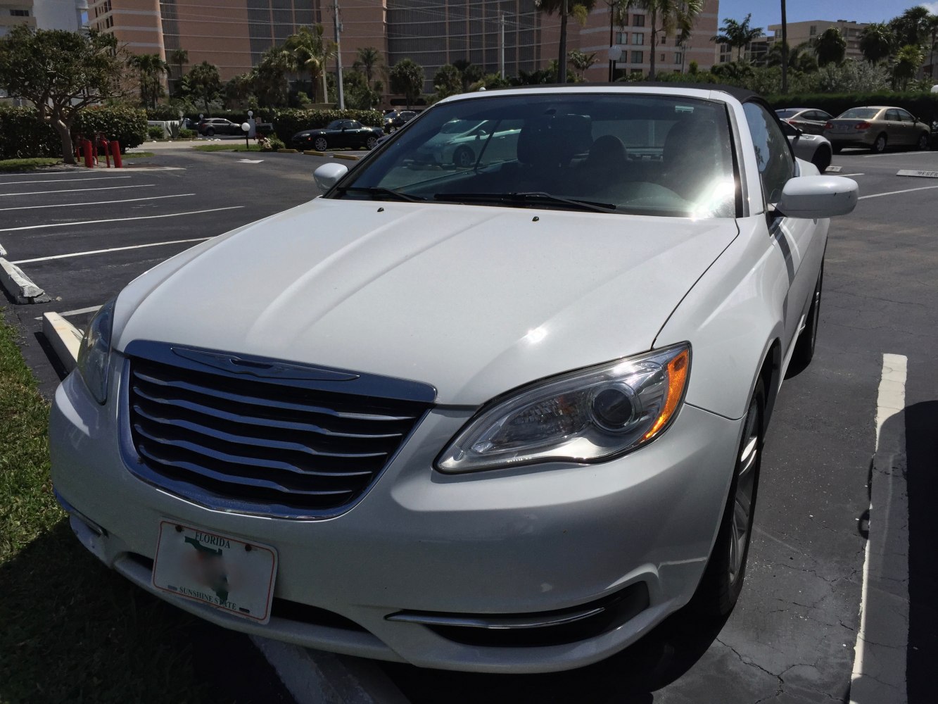 Front view with grille, headlights, and convertible roof