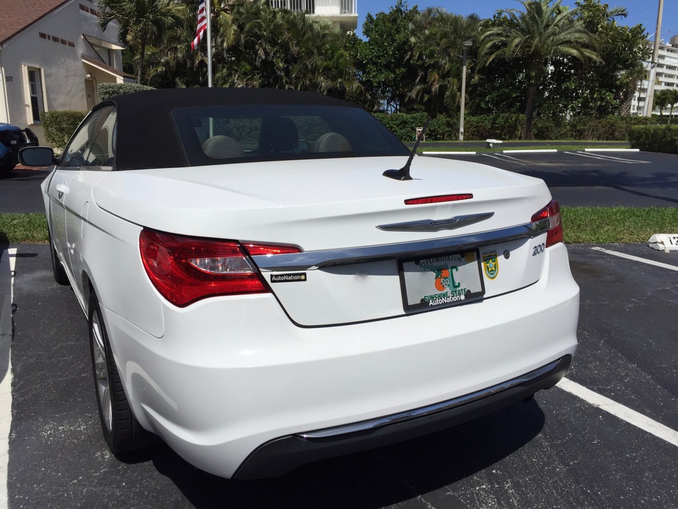 Rear view of white convertible with soft top and tail lights