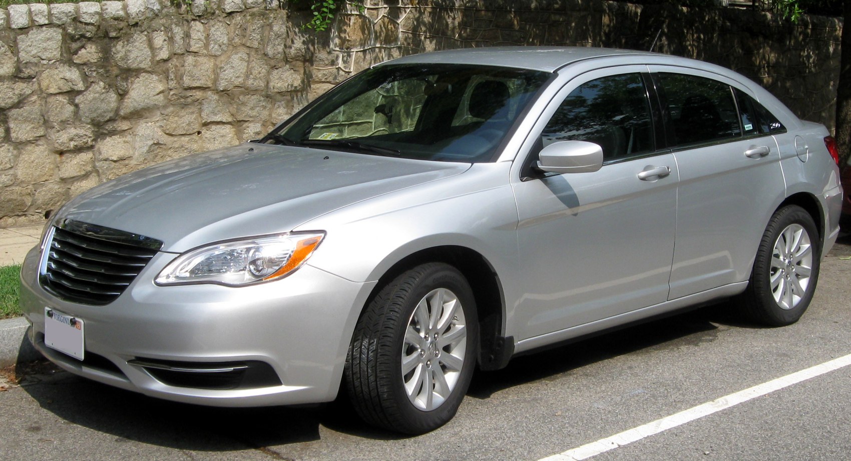 Silver sedan front-side view featuring headlights and alloy wheels