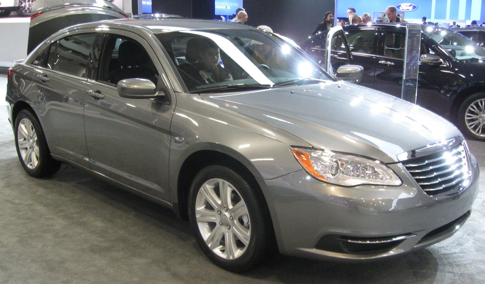 Silver sedan front side view with grille and headlights