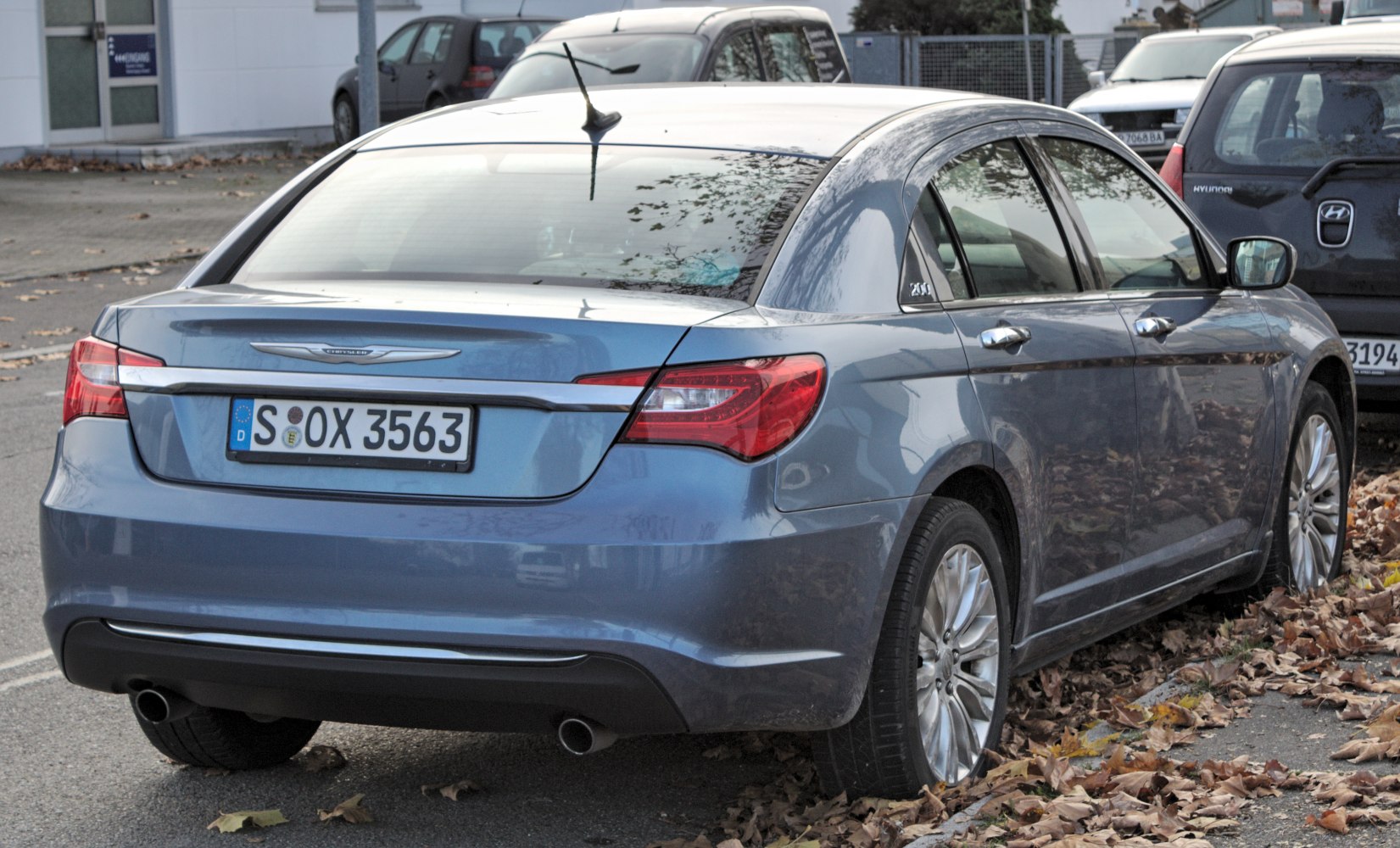 Rear view of a sedan highlighting taillights and dual exhaust