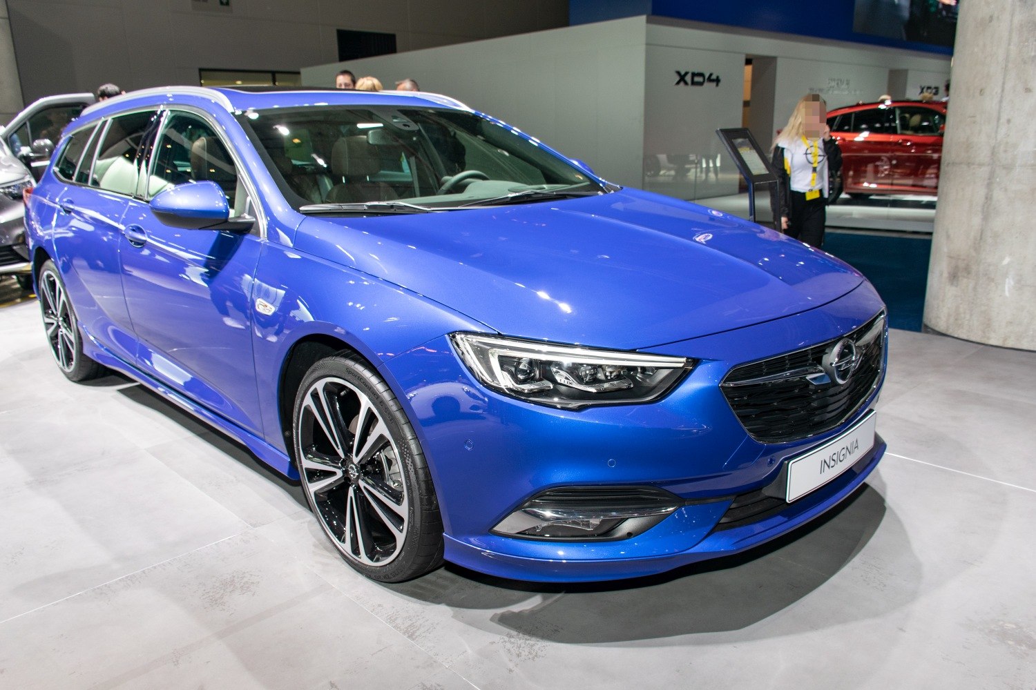 Sleek front fascia and sporty alloy wheels on a blue vehicle
