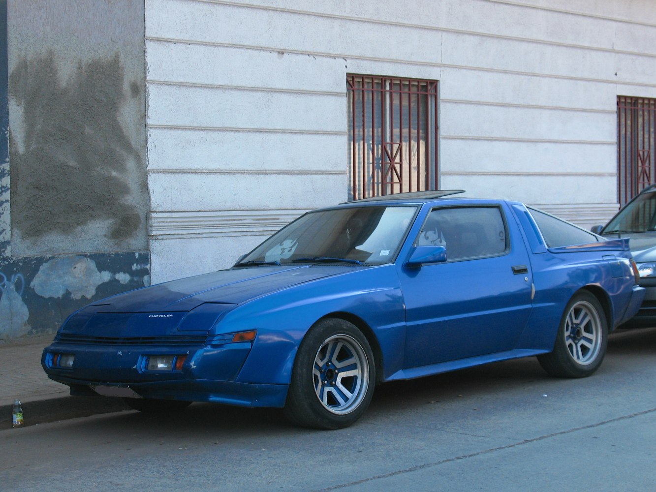 1980s two-door sports coupe with pop-up headlights and five-spoke wheels