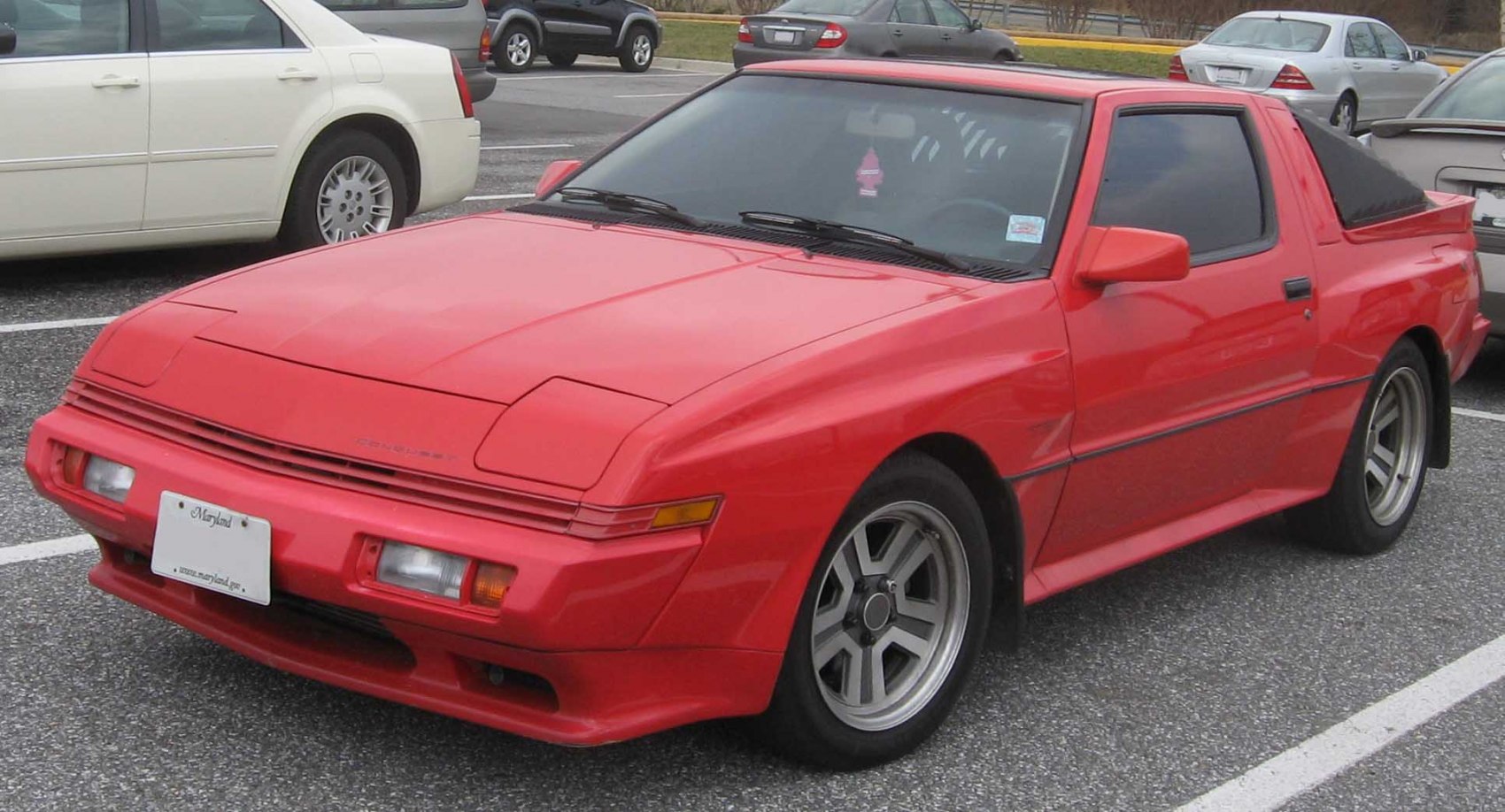 Red sports coupe with pop-up headlights and rear spoiler