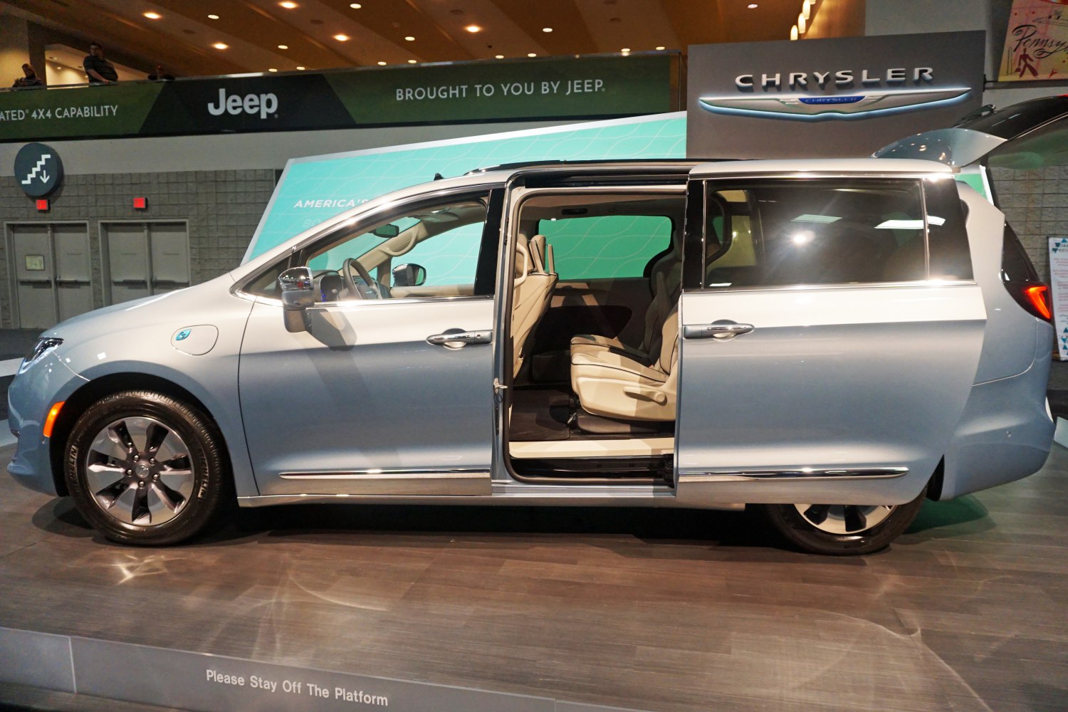 Side view of minivan with sliding doors open and beige interior seats
