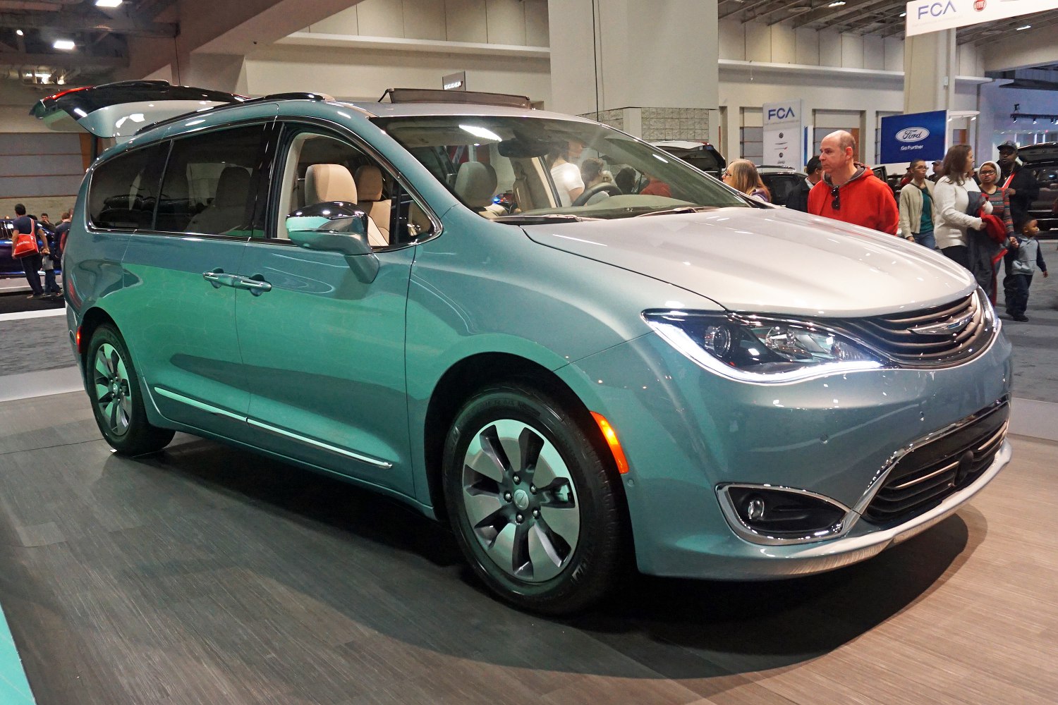 Front side view of minivan with modern headlights and aerodynamic design