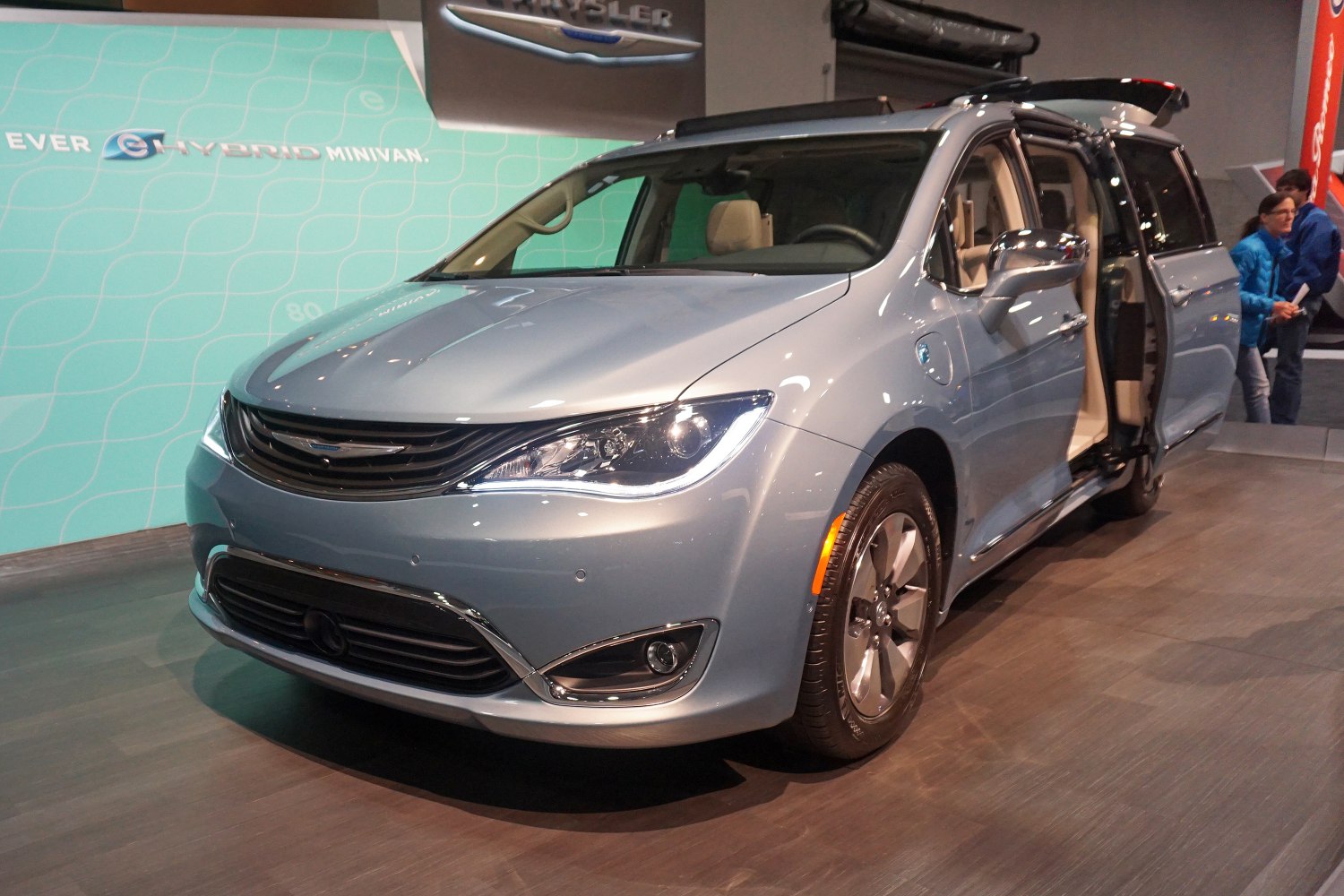 Front angled view of minivan with LED headlights and sliding door open
